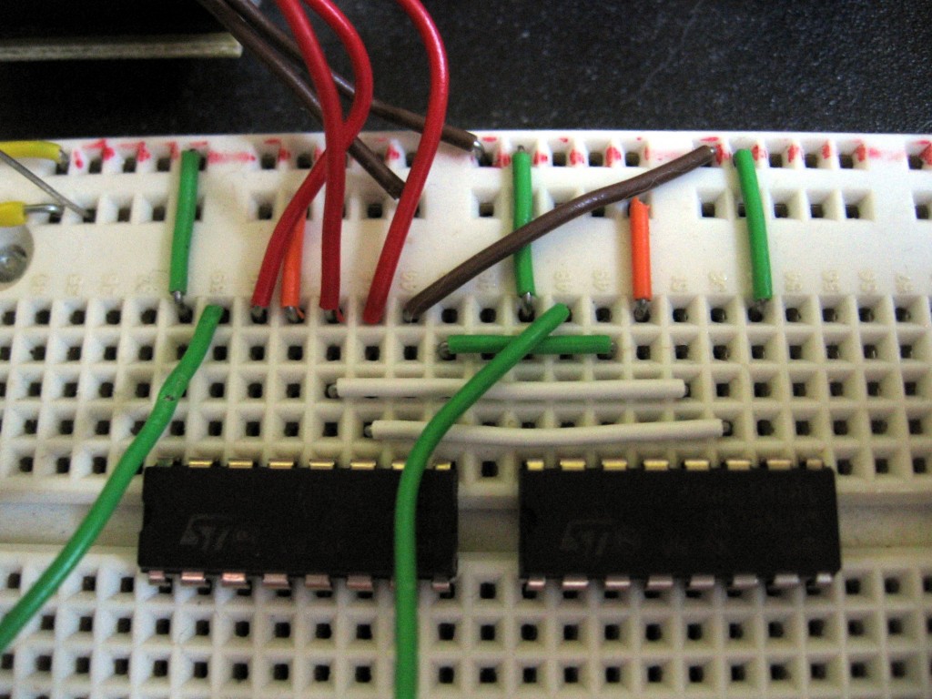 A pair of shift registers connected with jumper wires on a breadboard
